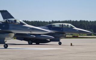Two F-16 aircraft standing on the tarmac