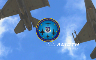 The Worldwide Review conference logo against a background of sky and two F-16 aircraft